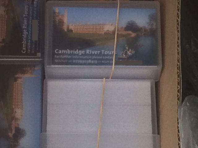 A box of business cards belonging to the fake Cambridge River Tours